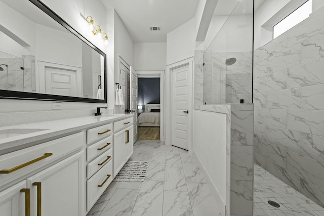 bathroom with vanity and a tile shower