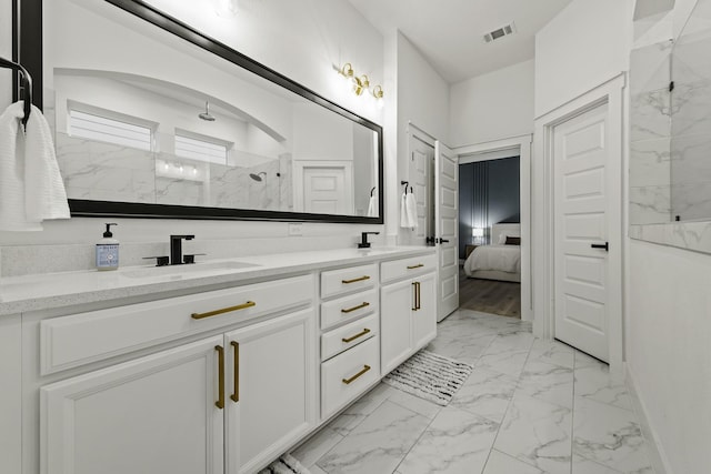 bathroom with vanity and a shower