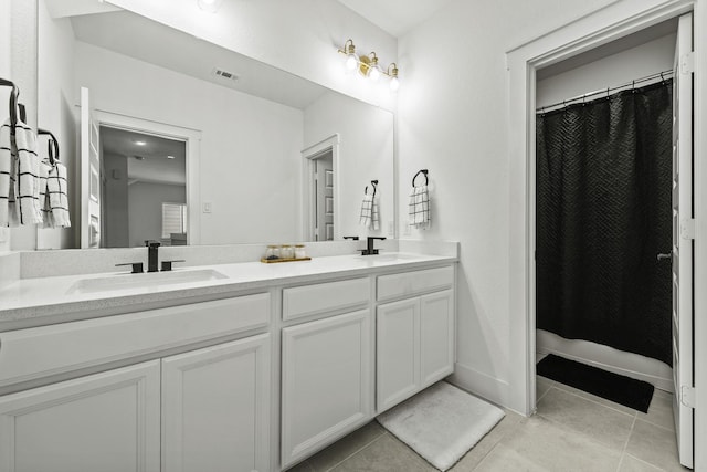 bathroom featuring tile patterned floors and vanity