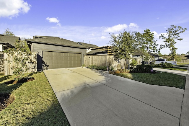 view of front of house featuring a front lawn and a garage