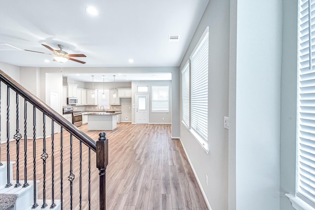 interior space featuring ceiling fan, sink, and hardwood / wood-style flooring