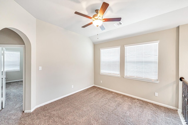 carpeted spare room with ceiling fan and lofted ceiling