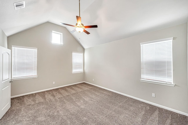 carpeted empty room with vaulted ceiling and ceiling fan