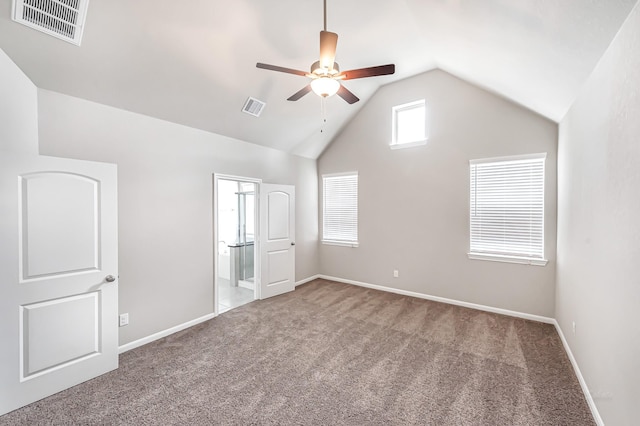 unfurnished bedroom featuring carpet flooring, ceiling fan, lofted ceiling, and ensuite bath