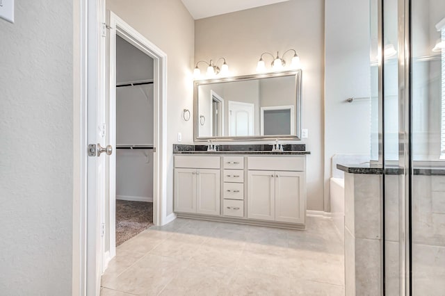 bathroom with tile patterned floors, vanity, and separate shower and tub