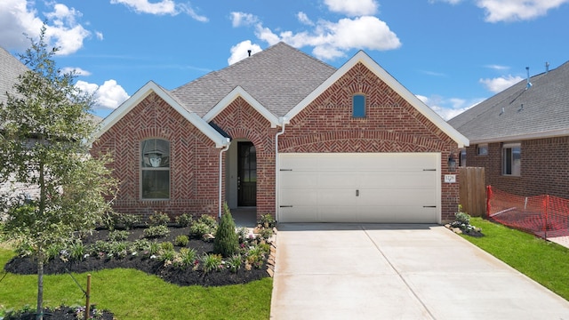 view of front of property with a front yard and a garage