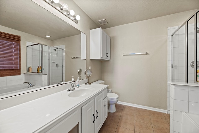 full bathroom featuring tile patterned floors, separate shower and tub, a textured ceiling, toilet, and vanity