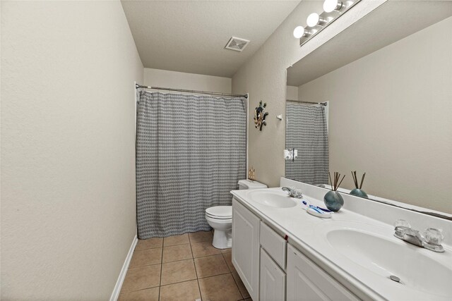 bathroom featuring walk in shower, tile patterned flooring, a textured ceiling, toilet, and vanity