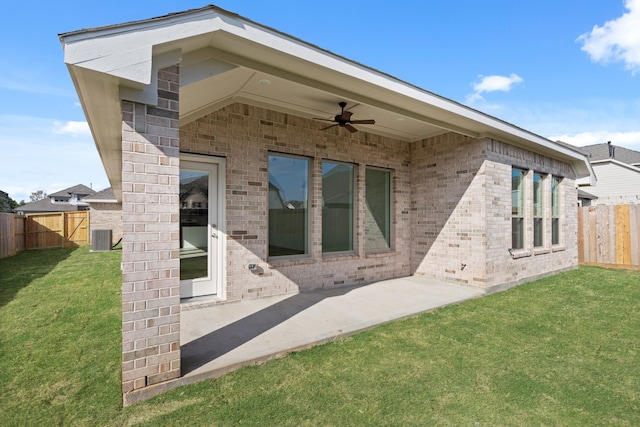 back of property with central air condition unit, ceiling fan, a patio area, and a lawn