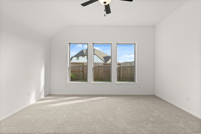 spare room featuring carpet flooring, ceiling fan, and vaulted ceiling