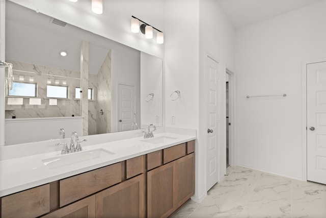 bathroom featuring a tile shower and vanity