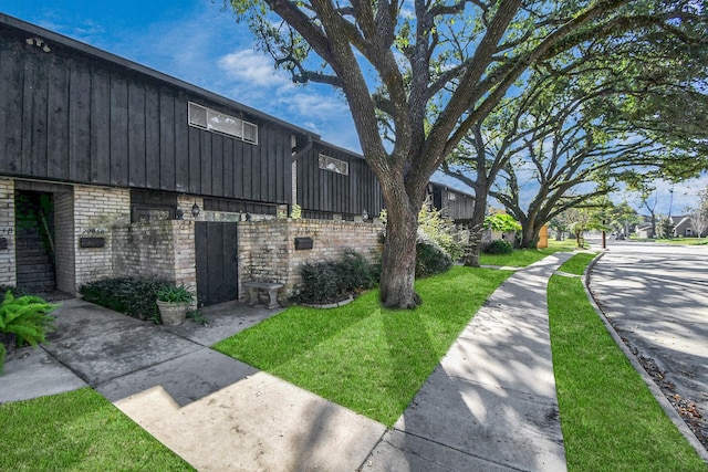 view of property exterior featuring a lawn