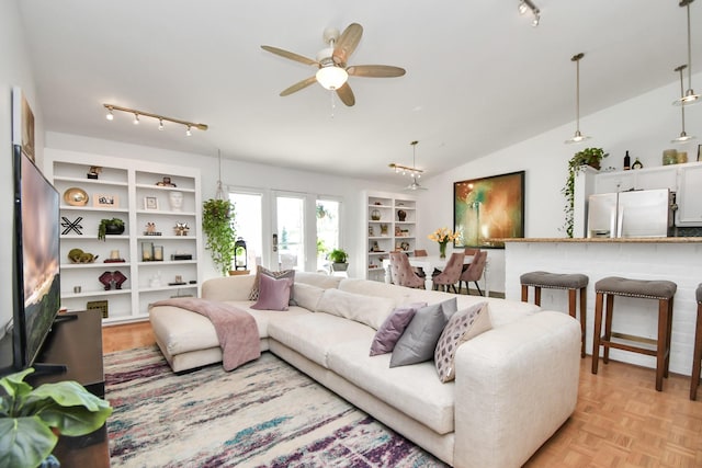 living room featuring light parquet flooring, ceiling fan, and lofted ceiling