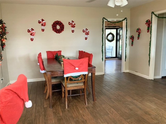 dining area featuring ceiling fan and dark wood-type flooring