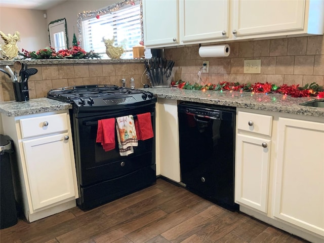 kitchen with tasteful backsplash, white cabinetry, and black appliances