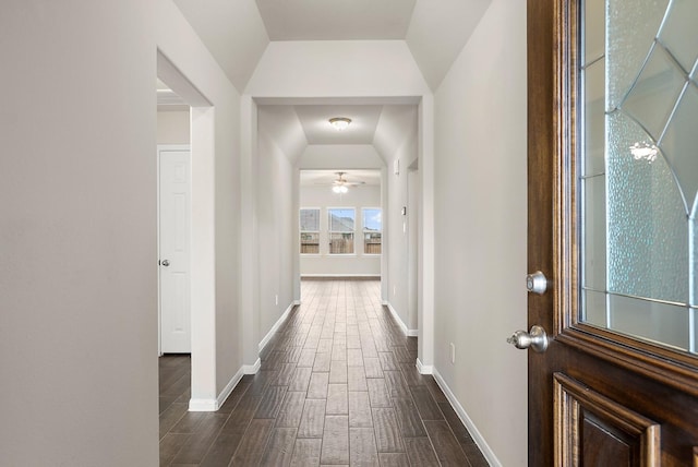 hallway with lofted ceiling