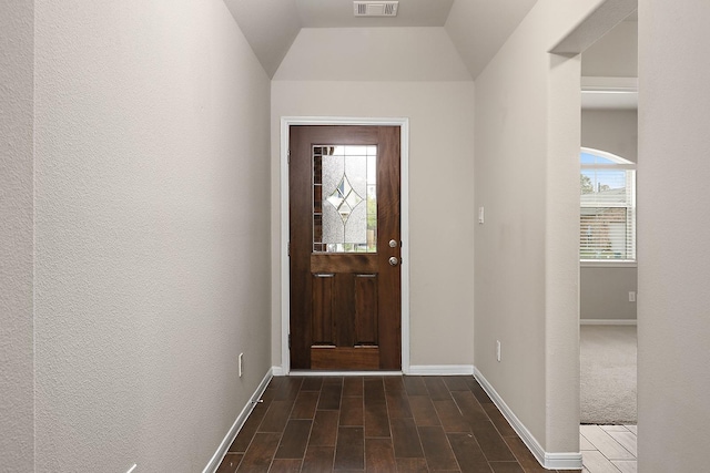 entrance foyer featuring vaulted ceiling