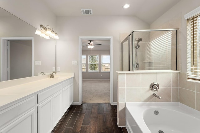 bathroom featuring ceiling fan, independent shower and bath, vanity, and vaulted ceiling