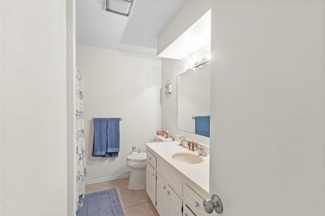 bathroom featuring tile patterned flooring, vanity, and toilet