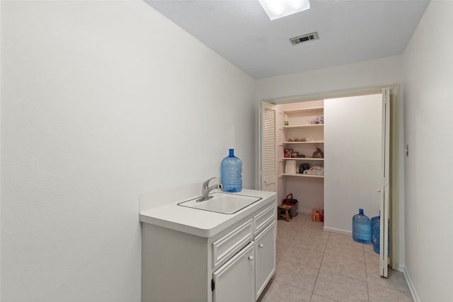 washroom featuring light tile patterned flooring and sink