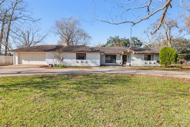 ranch-style home with a front lawn and a garage