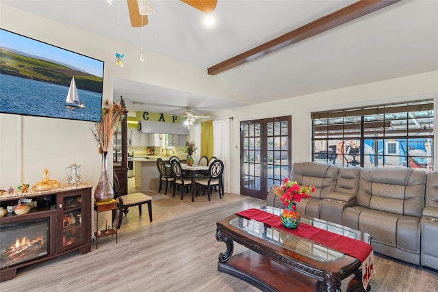 living room with light wood-type flooring, french doors, vaulted ceiling with beams, and a healthy amount of sunlight