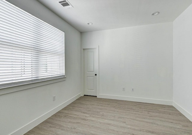 spare room with light wood-type flooring