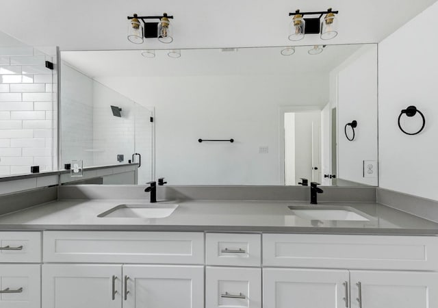 bathroom with vanity and a shower with shower door