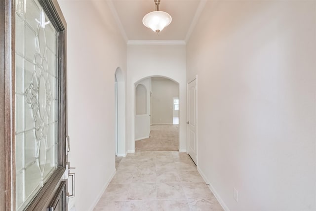 hallway featuring light carpet and crown molding