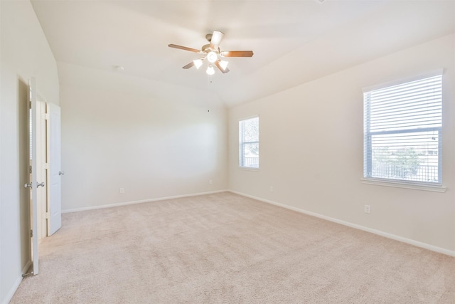 carpeted empty room with ceiling fan and vaulted ceiling