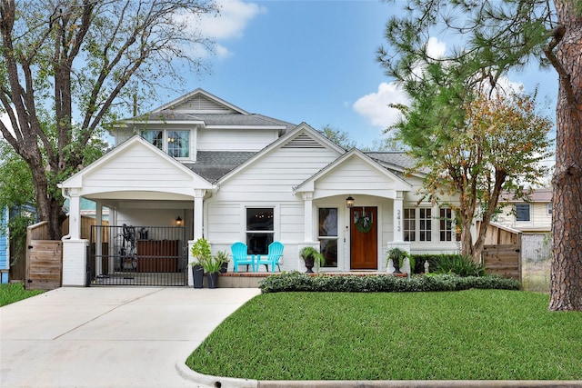 view of front of house with covered porch and a front lawn