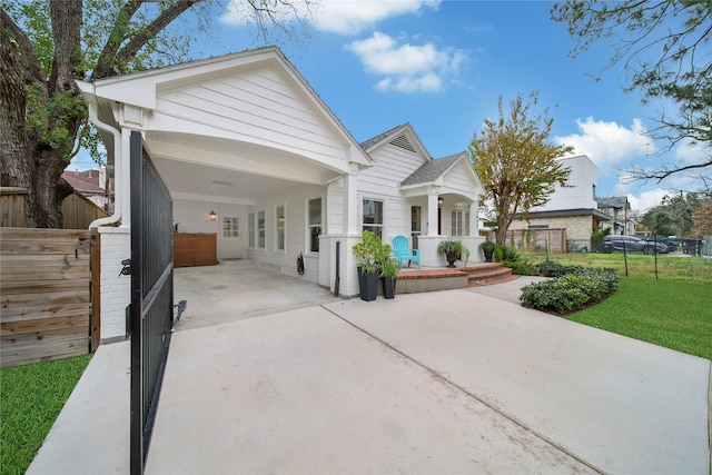 view of front of property with covered porch and a carport