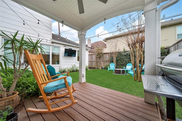 deck with ceiling fan and a lawn