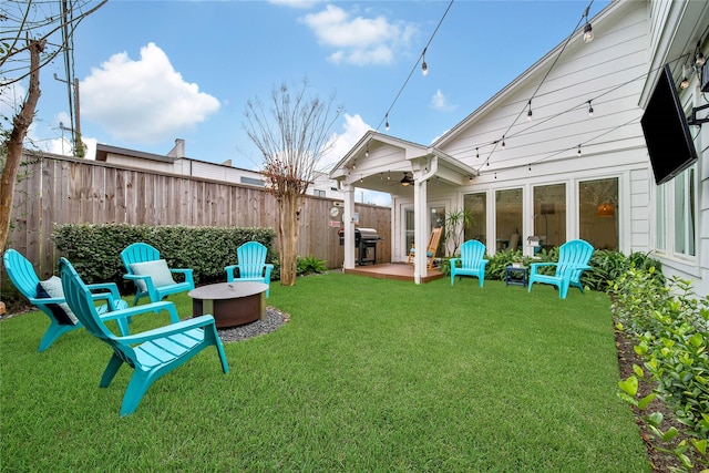 view of yard featuring a patio and an outdoor fire pit