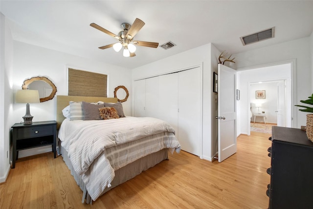 bedroom with light wood-type flooring, a closet, and ceiling fan