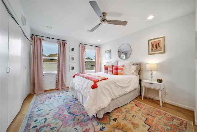 bedroom featuring ceiling fan and light hardwood / wood-style flooring