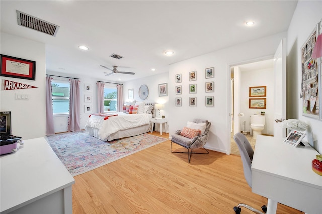 bedroom featuring ceiling fan, wood-type flooring, and connected bathroom