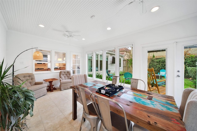 tiled dining room featuring ceiling fan, french doors, and crown molding