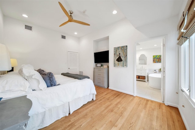 bedroom featuring ceiling fan, light wood-type flooring, and connected bathroom