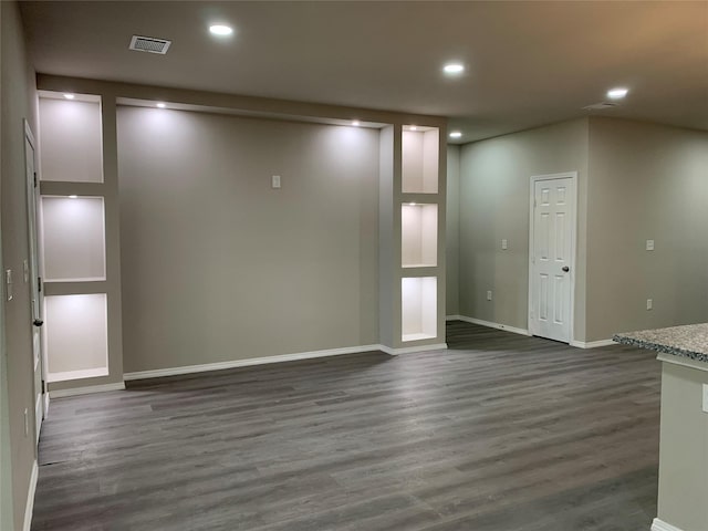 empty room with dark hardwood / wood-style flooring