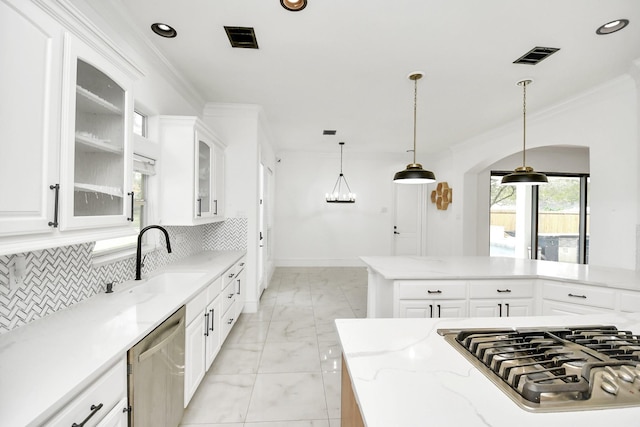 kitchen featuring white cabinets, decorative light fixtures, stainless steel appliances, and sink