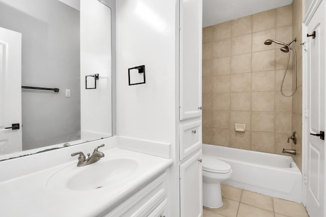 full bathroom with tile patterned floors, vanity, tiled shower / bath combo, and toilet