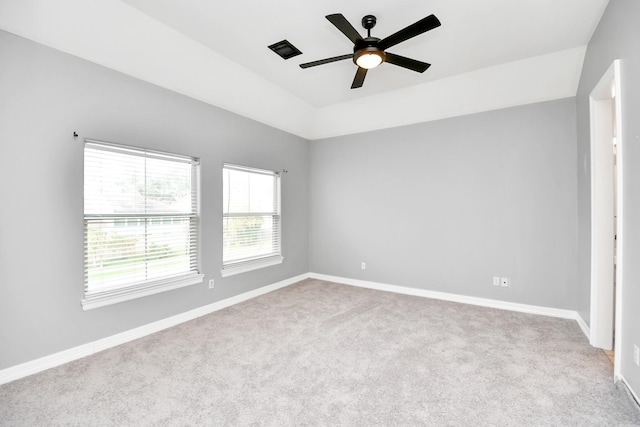 spare room with light colored carpet and ceiling fan