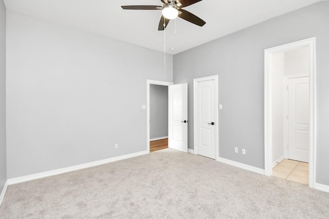 unfurnished bedroom with light carpet and ceiling fan