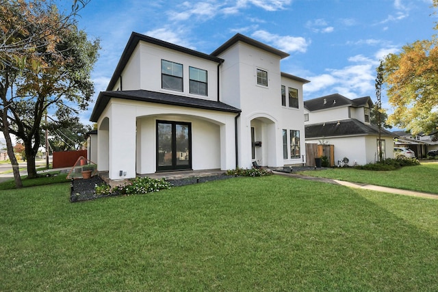 back of house featuring a yard and french doors