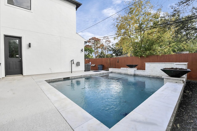 view of pool with a patio and central AC