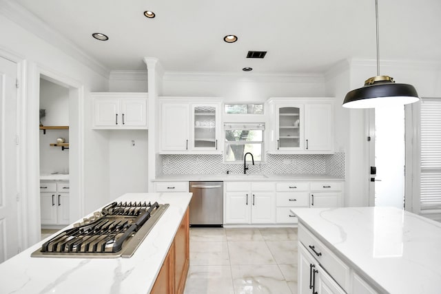 kitchen featuring white cabinets, light stone counters, hanging light fixtures, and appliances with stainless steel finishes