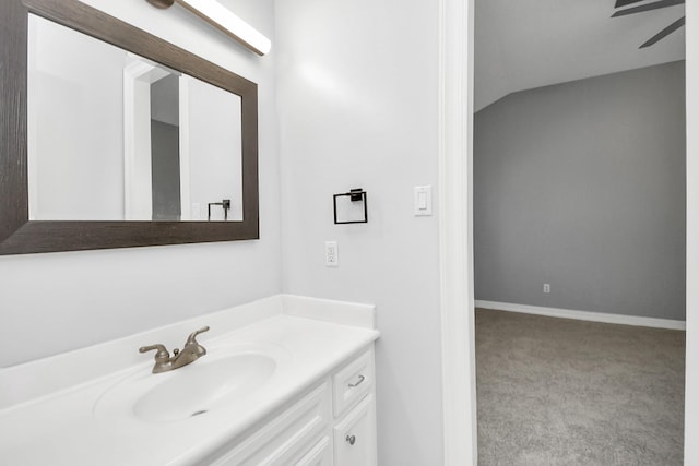 bathroom featuring ceiling fan, vanity, and lofted ceiling