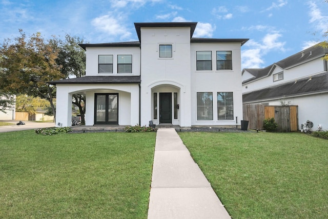 view of front of property with a front yard and french doors