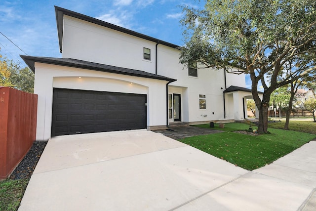 view of front of house with a front lawn and a garage